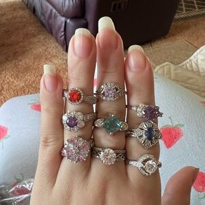 Pink Jewelry Box with Assorted Silver Tone Rings With Colorful Gem Stones.